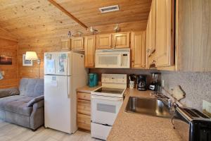 a kitchen with a white refrigerator and a sink at NC 12 56821-10 Condo in Hatteras