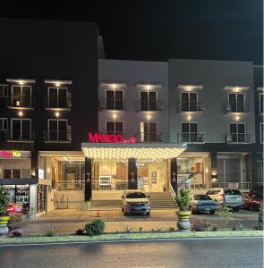 a hotel with cars parked outside of it at night at Mango Suites in Tuguegarao City