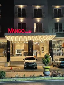 een minivan geparkeerd voor een winkel 's nachts bij Mango Suites in Tuguegarao City