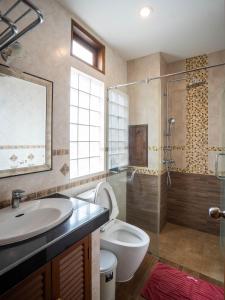 a bathroom with a sink and a toilet and a shower at Baan Sailom Hotel Phuket - Sha Extra Plus in Karon Beach