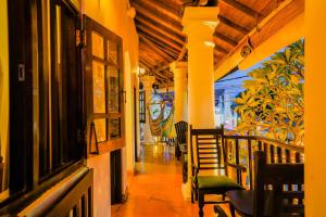a corridor of a restaurant with tables and chairs at Fort Dew Guest House in Galle