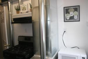 a kitchen with a stove and a microwave at Laytons Loft Bed and Breakfast in Manti