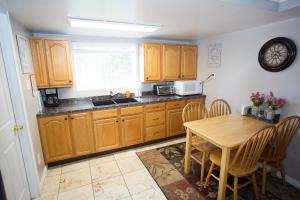 a kitchen with wooden cabinets and a table with chairs at Laytons Loft Bed and Breakfast in Manti
