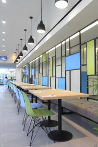 a long conference room with long tables and chairs at Hotel Citradream Semarang in Semarang