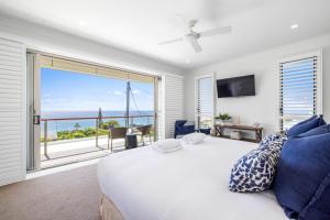 a bedroom with a bed and a large window at Horizons in Woolgoolga
