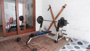 a gym with a bench press and a mirror at Casa La Palma Habitación Cielo in Medellín