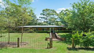 a house with a fence in front of it at Alba Gardens in Bundanoon