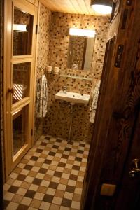a bathroom with a sink and a checkered floor at Kauba Apartment in Viljandi