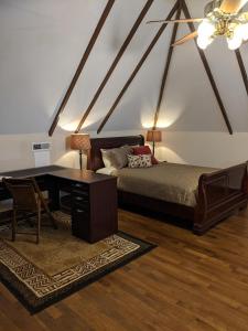 a bedroom with a bed and a desk and a table at The Avanti Houses in South Bend