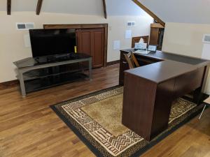 an office with a desk and a television in a room at The Avanti Houses in South Bend