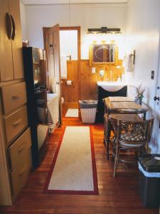 a bathroom with a table and a kitchen with a sink at The Avanti Houses in South Bend