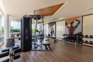 a gym with exercise equipment and a wall mural at Aristo 2 Phuket in Phuket Town