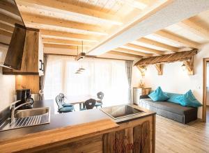 una cocina con fregadero y un sofá en una habitación en Thomashof, en Pfelders