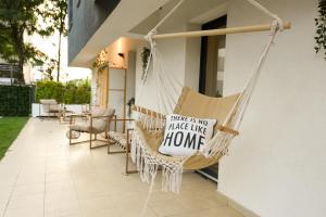 a hammock on a porch with a sign that says there is not take like at VACATION FEEL - 2BR Apartment with Terrace & Private Parking in Baneasa in Bucharest
