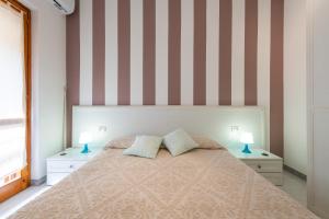 Кровать или кровати в номере Bilocale con Piscina a Villasimius