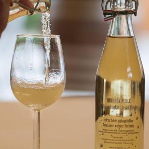 a bottle of wine being poured into a wine glass at Viktor Bor- és Vendégház**** in Balatonmáriafürdő