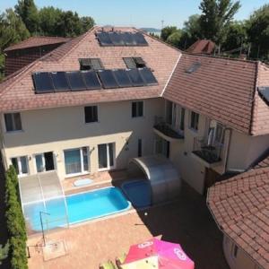an aerial view of a house with a swimming pool at Viktor Bor- és Vendégház**** in Balatonmáriafürdő