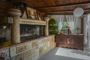 a living room with a stone fireplace in a house at Venetian Hill House in Áyios Dhimítrios