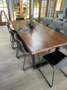 a wooden table with chairs around it in a room at The Retreat Tamborine Mountain in Mount Tamborine