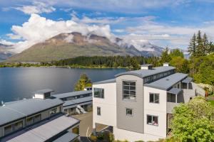 an aerial view of a house with a lake and a mountain at Exciting Queenstown in Queenstown