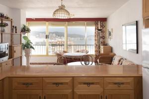 a kitchen with a view of a living room at Arensol Esc-A, 13º-51 in Cullera