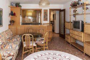 a living room with a couch and a table at Arensol Esc-A, 13º-51 in Cullera