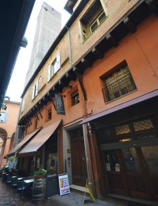 a building with tables and chairs outside of it at 4-Tourist House Bologna-Studio - Self check-in in Bologna