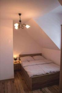 a bedroom with a bed in a attic at AgroPrzystań in Zubrzyca Górna +6 photos