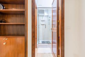 a bathroom with a glass door leading to a shower at Teatro Politeama and Teatro Massimo Cozy Apartment in Palermo