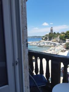 a balcony with a view of a beach and the ocean at Rooms Milena in Lopud Island