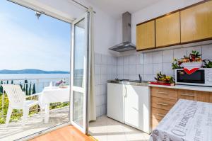 a kitchen with a view of the ocean at Apartments Cypress Sea Cove in Slano