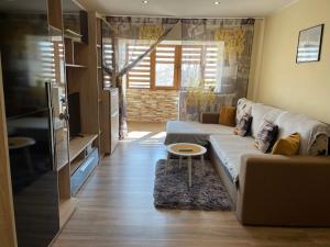 a living room with a couch and a table at Bavaria Apartament in Mangalia