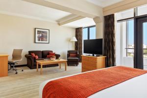 a hotel room with a bed and a flat screen tv at Crowne Plaza Muscat, an IHG Hotel in Muscat