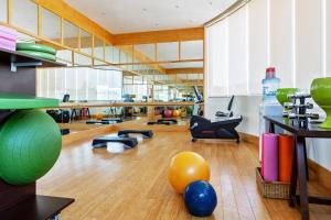 a large room with a gym with balls on the floor at Crowne Plaza Muscat by IHG in Muscat