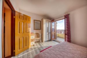 1 dormitorio con 1 cama y puerta a un balcón en Apartments Kristić, en Dubrovnik