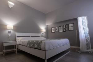 a bedroom with a bed and two lamps and a window at RESIDENCE TERME ISOLA D'ELBA SRL in Portoferraio