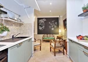 a kitchen with a sink and a chalkboard on the wall at Piranesi Charmsuite in Rome