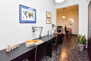 a room with a desk and a table with chairs at City Vibes "by Checkin" in Heraklio Town
