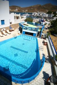 an overhead view of a large blue swimming pool at Poseidon Hotel in Ios Chora