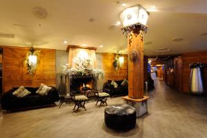 a lobby with a fireplace and a lamp in a room at Principi di Piemonte Sestriere in Sestriere +52 photos