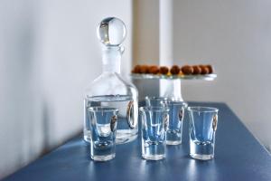 a group of glasses and a bottle on a table at City Vibes "by Checkin" in Heraklio Town