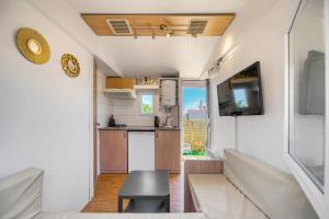 a small kitchen and living room of a caravan at Casa Amarelo-Tiny House with fantastic view-pool and close to the beaches in Silves