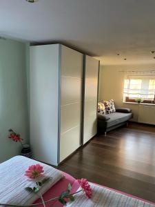 a bedroom with a large white cabinet and a couch at Rosental in Stollberg