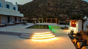 a patio with a pool with lights on it at Ethereal Apartments in Agrari