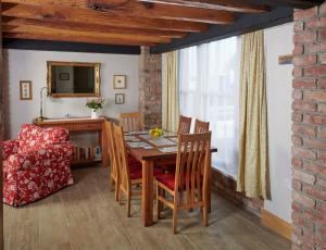 a dining room with a table and chairs and a mirror at Ballykeel Farm, Mourne Mountains in Ballymartin