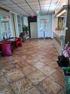 a lobby with a stone floor and a table and chairs at Hotel Montenegro in Bruntál