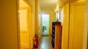 a hallway with a room with a fire hydrant and a refrigerator at Private cozy room 2 with shared kitchen in appartment in Belgrade