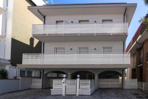 a large white building with a balcony on it at Casa Plauto con appartamento grande in Bellaria-Igea Marina