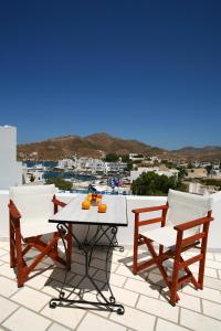 a table and two chairs sitting on a roof at Poseidon Hotel in Ios Chora