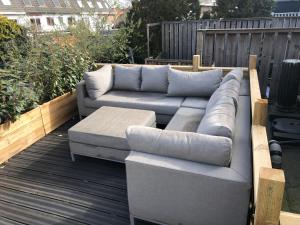 a couch sitting on top of a deck at Thomasloft in Oegstgeest